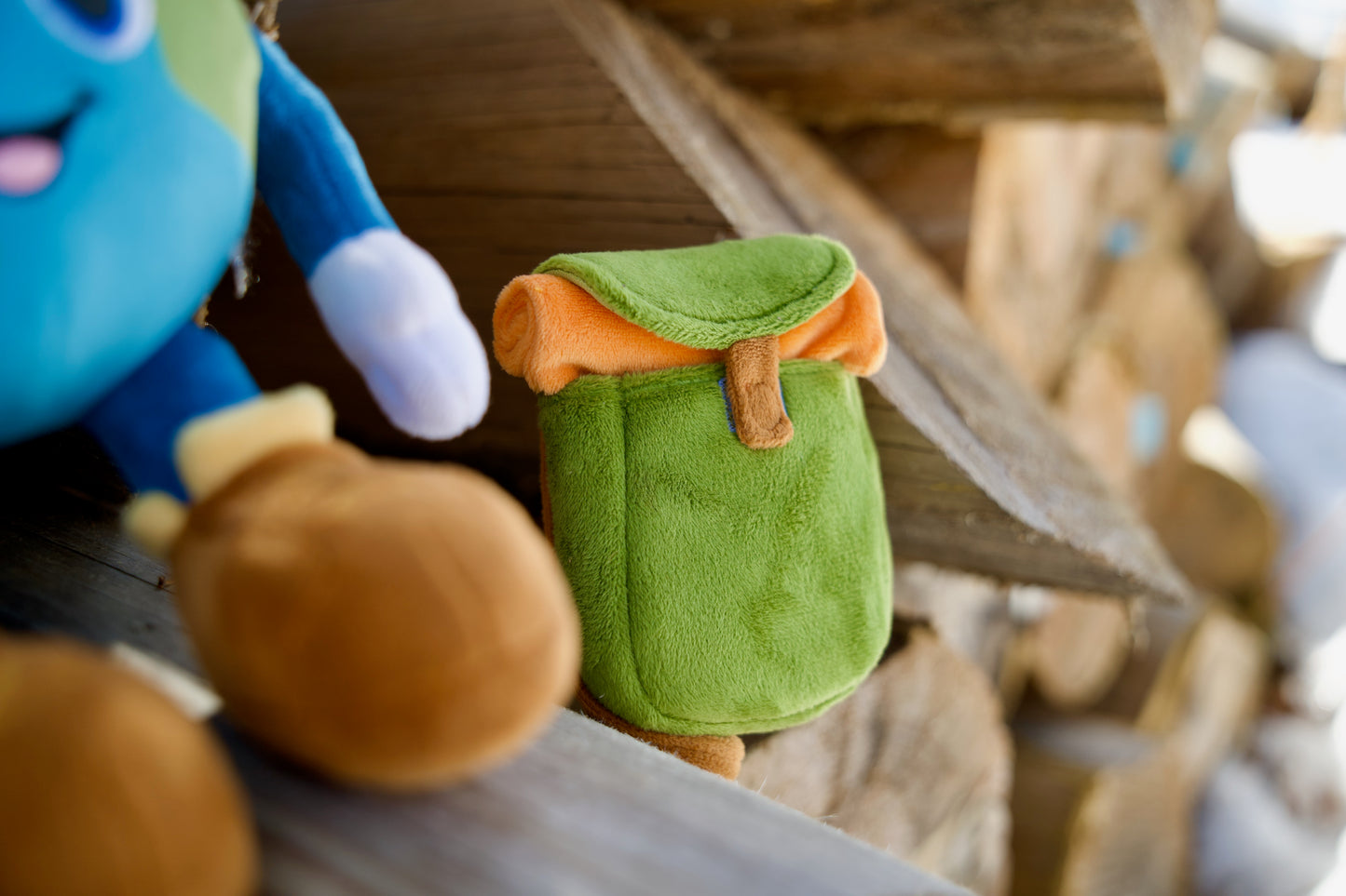Plush toys on a wooden surface with a blurred background